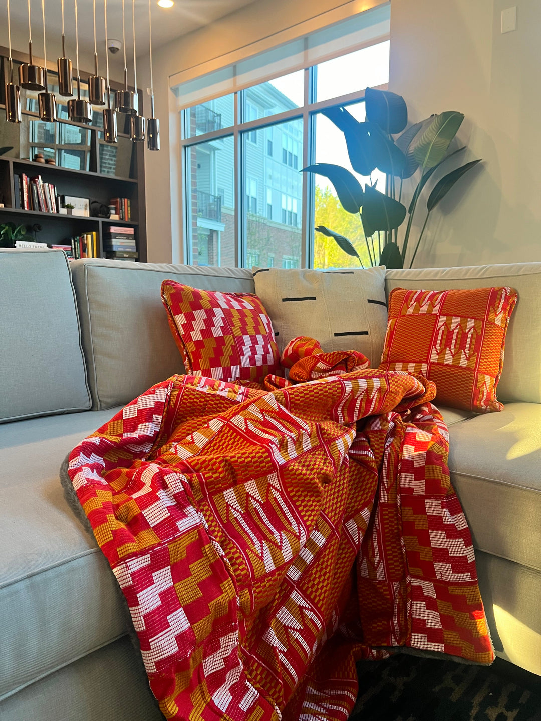 blankets showcase vibrant and bold Kente patterns that are deeply rooted in Ghanaian culture. The intricate geometric designs, with their vibrant colors and symbolic motifs, tell stories of history, wisdom, and cultural significance.