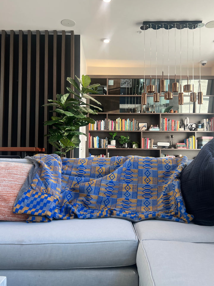 Luxury Kente throw blanket by Obrempong Home, showcasing traditional Kente cloth patterns, perfect for Kente-style interior design and cultural Kente accessories.