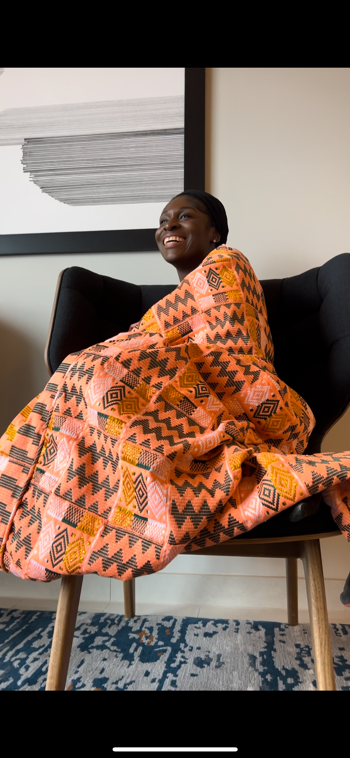 "Immerse yourself in the cultural heritage of Ghana with this stunning kente textile, featuring intricate weaving techniques and traditional symbols that reflect the prosperity and celebration woven into every thread."