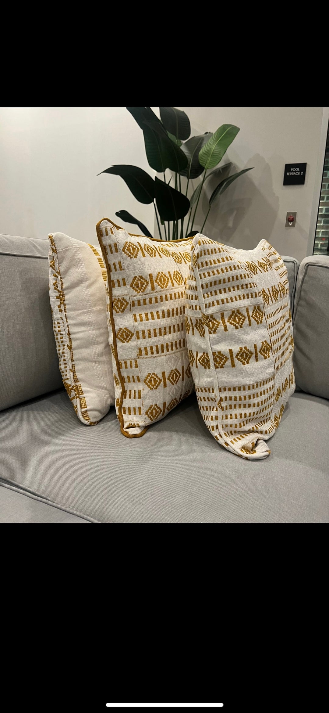 Obrempong Home's handwoven Kente throw pillow, showcasing traditional Kente cloth patterns, an essential element in Kente-style interior design and vibrant Kente patterns for home decor