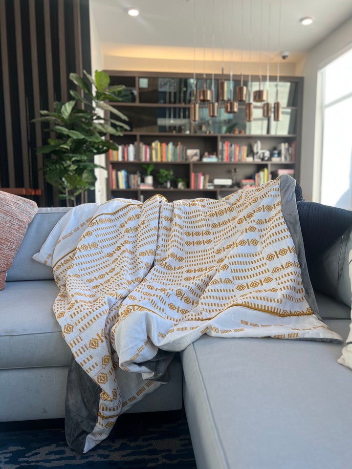 African-inspired Kente throw blanket by Obrempong Home, featuring traditional Kente cloth patterns, essential for Kente-style interior design and cultural Kente home textiles