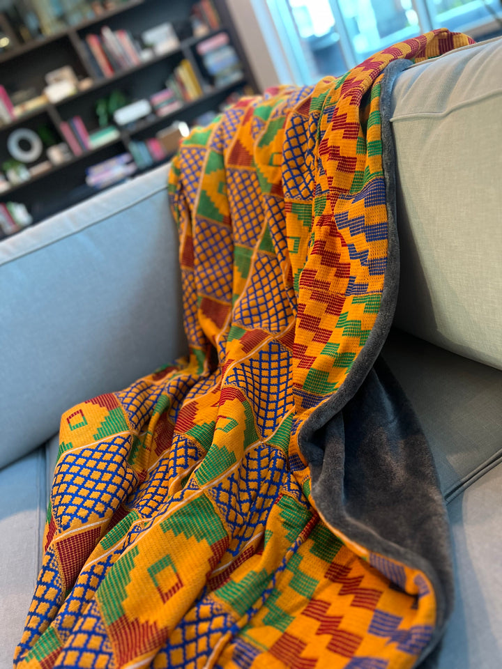 Meticulously crafted by skilled artisans, this throw blanket is a stunning representation of the vibrant and intricate Kente weaving tradition.