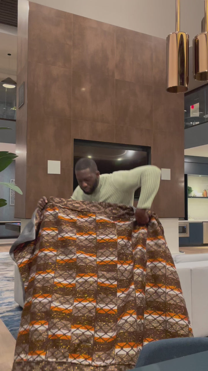 "Artisanal kente throw blanket handcrafted in Ghana's vibrant colors"-